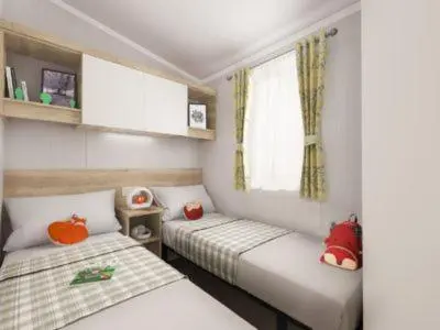 a small room with two beds and a window at Mowbreck Park in Kirkham