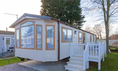 a white tiny house with windows and a staircase at Mowbreck Park in Kirkham