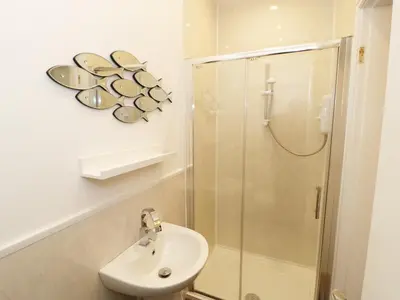 a bathroom with a shower and a sink at Foxes Den in Thornton