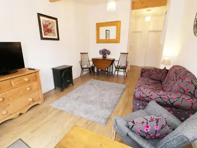 a living room with a couch and a tv at Foxes Den in Thornton