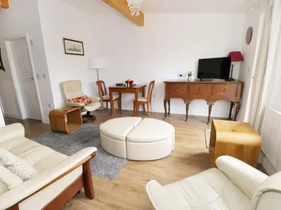 a living room with white furniture and a piano at The Hen House in Thornton