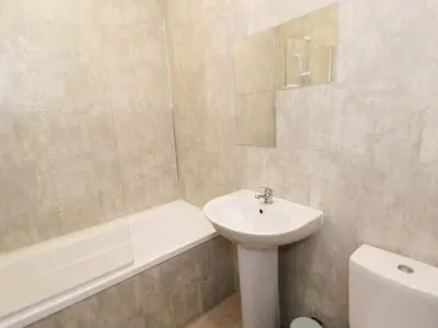 a bathroom with a sink and a tub and a toilet at The Hen House in Thornton