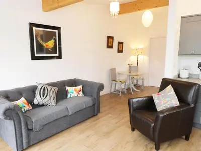 a living room with a couch and a chair at The Old Stables in Thornton