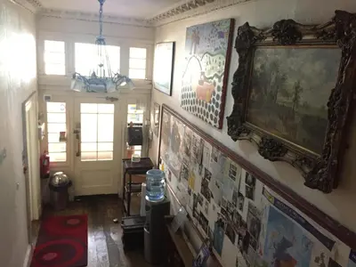 a hallway with pictures on the walls of a house at Embassie Backpackers in Liverpool