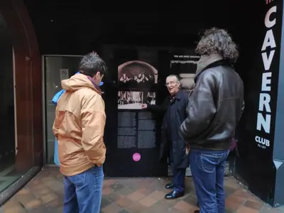 a group of men standing outside of a store at Embassie Backpackers in Liverpool