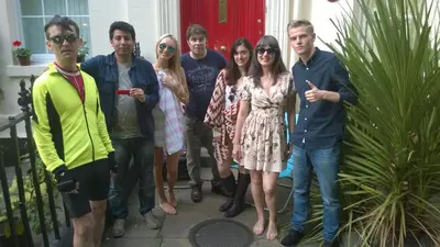 a group of people posing for a picture on a porch at Embassie Backpackers in Liverpool