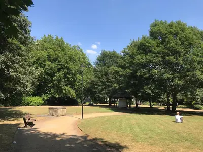 a park with two people sitting in the grass at Embassie Backpackers in Liverpool