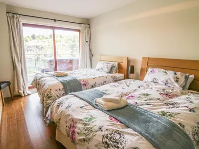 two beds in a bedroom with a window at Boavista in Carnforth