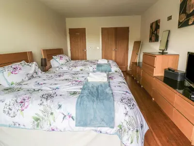 a bedroom with a bed with a dress on it at Boavista in Carnforth