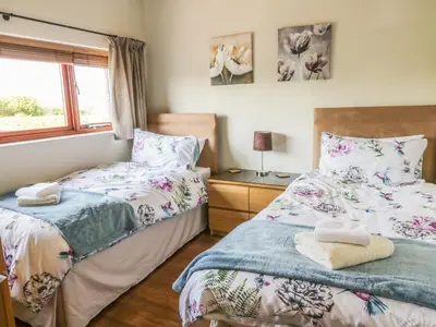 a bedroom with two beds and a window at Boavista in Carnforth