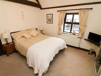 a bedroom with a bed and a window at 1 The Stables in Clitheroe