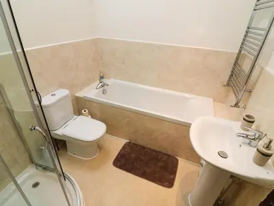 a bathroom with a toilet and a sink and a bath tub at 1 The Stables in Clitheroe