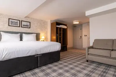 a hotel room with a bed and a chair at Offshore - The Inn Collection Group in Lytham St Annes