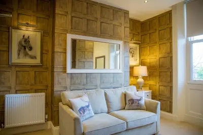 a living room with a couch and a mirror at Winckley Stays in Preston