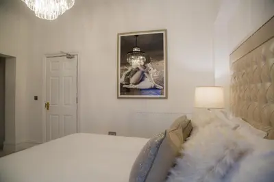 a bedroom with a bed and a picture on the wall at Winckley Stays in Preston