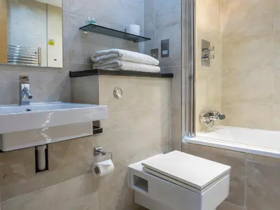 a bathroom with a sink and a toilet and a tub at Posh Pads - Liverpool 1 - Apart-Hotel in Liverpool