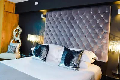 a bedroom with a large bed with a large headboard at Posh Pads - Liverpool 1 - Apart-Hotel in Liverpool
