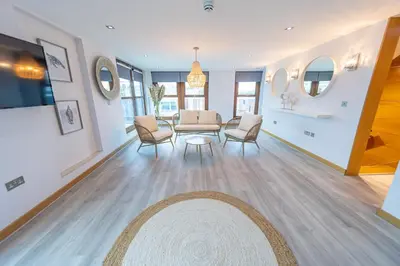 a living room with a table and chairs at Posh Pads - Liverpool 1 - Apart-Hotel in Liverpool