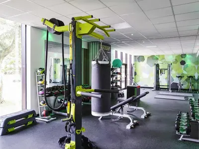 a gym with exercise equipment in a room at Mercure St Helens in Saint Helens