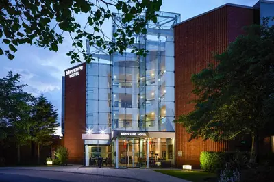 a large glass building with a sign on it at Mercure St Helens in Saint Helens