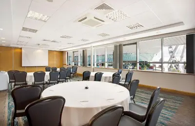 a conference room with a white table and chairs at Leonardo Hotel Liverpool in Liverpool