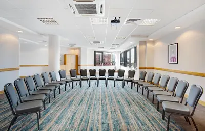 a conference room with chairs in a row at Leonardo Hotel Liverpool in Liverpool