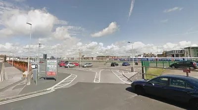 a parking lot with cars parked in a parking lot at Phoenix Guest House in Blackpool