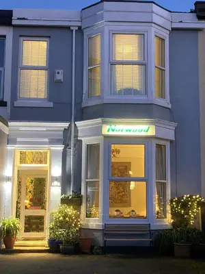 a blue building with a sign in front of it at The Norwood Guest House in Southport
