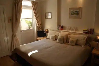 a bedroom with a bed with pillows and a window at The Norwood Guest House in Southport