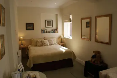 a bedroom with a bed and a teddy bear in it at The Norwood Guest House in Southport