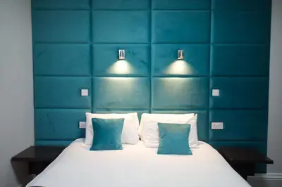 a bedroom with a bed with blue walls and two pillows at The Bromley in Blackpool
