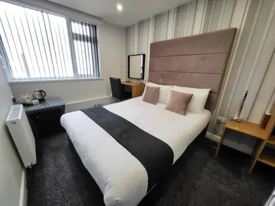 a hotel room with a large white bed with pillows at The Bromley in Blackpool