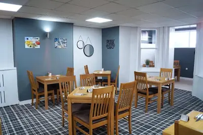 a dining room with wooden tables and chairs at The Bromley in Blackpool