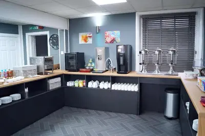a coffee shop with a counter in a room at The Bromley in Blackpool