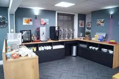 a coffee shop with blue walls and a counter at The Bromley in Blackpool
