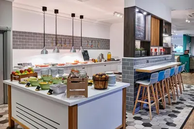 a kitchen with a counter with food on it at Holiday Inn Haydock by IHG in Haydock