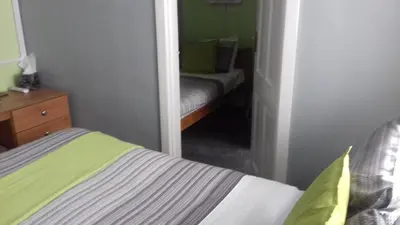 a small bedroom with a bed and a mirror at Elmfield in Blackpool