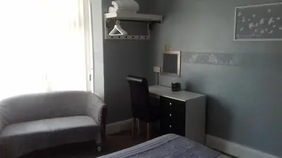 a bedroom with a bed and a desk and a chair at Elmfield in Blackpool