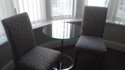 two chairs and a glass table in a room at Elmfield in Blackpool