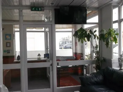 a living room with sliding glass doors and a tv at Elmfield in Blackpool
