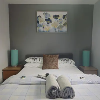 a bedroom with a bed with towels on it at Denville Hotel in Blackpool