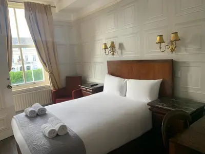 a hotel room with a bed with two rolled towels at Beech Mount Hotel - Free Parking in Liverpool