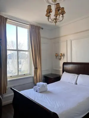 a bedroom with a bed with a teddy bear on it at Beech Mount Hotel - Free Parking in Liverpool