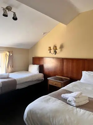a hotel room with two beds and a window at Beech Mount Hotel - Free Parking in Liverpool