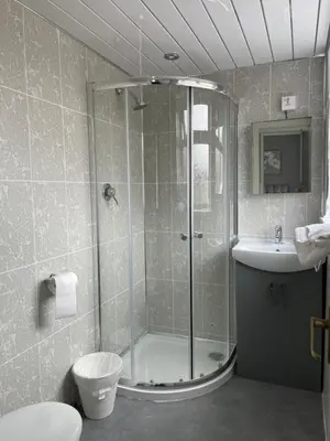a bathroom with a shower and a toilet and a sink at Sandford Promenade in Blackpool