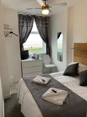 a bedroom with a bed with two towels on it at Sandford Promenade in Blackpool