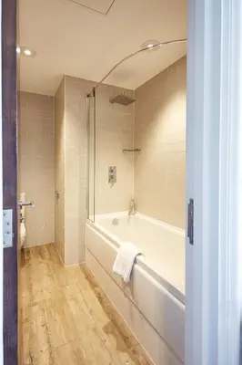 a bathroom with a bath tub and a shower at Toll House Inn in Lancaster