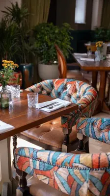 a wooden table with a chair and a table and chairsuggest at Toll House Inn in Lancaster