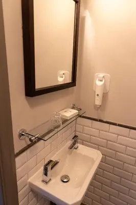a white bathroom with a sink and a mirror at Hartwood Hall by Greene King Inns in Chorley
