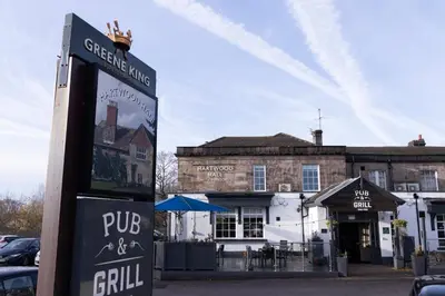 a pub sign in front of a building at Hartwood Hall by Greene King Inns in Chorley